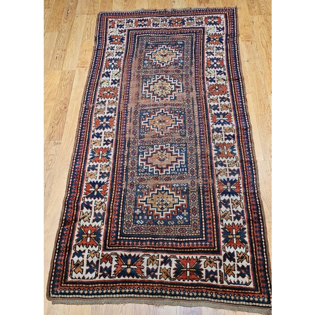 An exceptional 19th century Caucasian Kazak area rug, handwoven in the late 1800s, showcasing five striking Memling Gul...