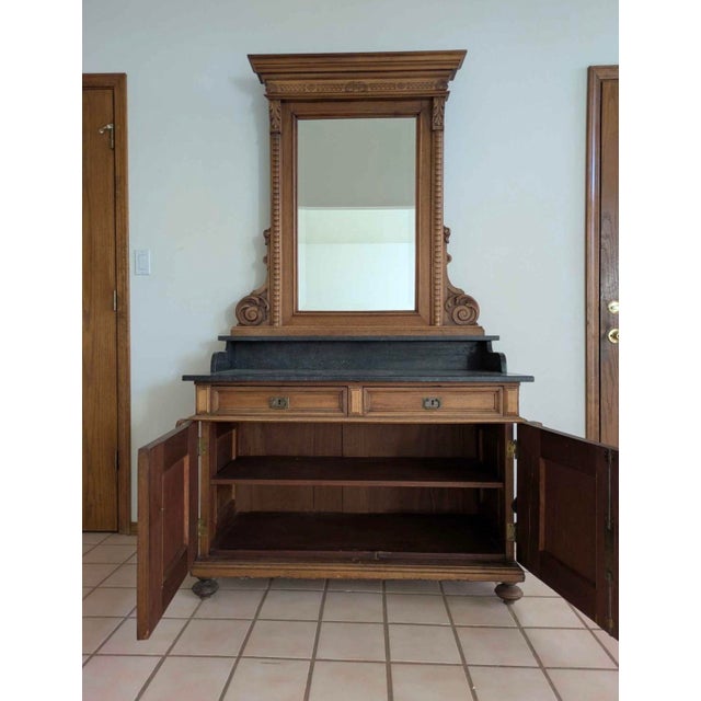 ncredibly beautiful ornate antique Victorian sideboard with a stone top. The large decorative mirror featuring carved...