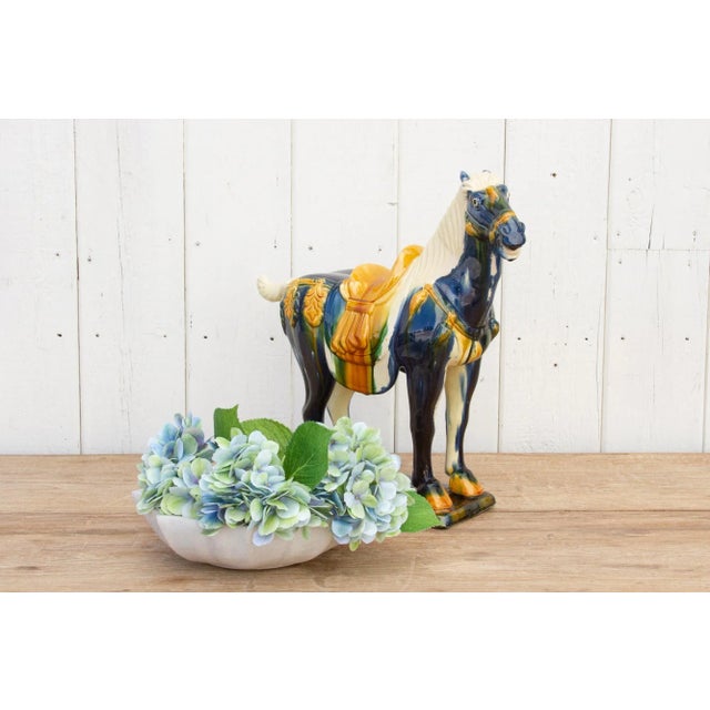 A large vintage Tang style Sancai glazed terracotta horse. This exquisite piece features a striking blue color glazed...
