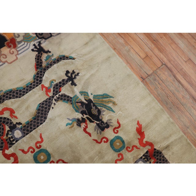 A 3rd quarter of the 20th-century Tibetan rug with a dragon motif on a beige field Size: 4'4'' x 6'10''.
