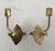 This pair of Hollywood Regency style drapery tie backs feature a singular curved arm with a three dimensional , intricate...