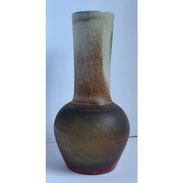 Handsomely shaped with beautiful natural coloring this one-of-a-kind large earthenware vase was raku-fired. Colors: Cream,...