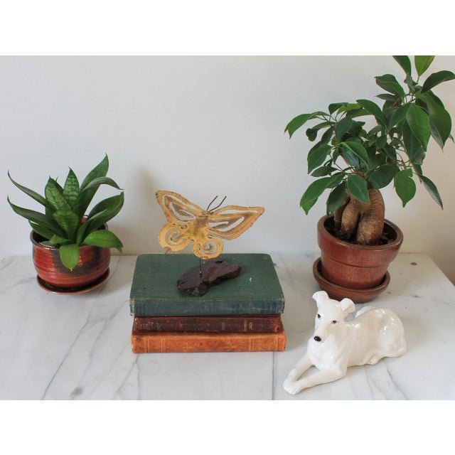 Mid-century brass brutalist style butterfly with wood base. No makers mark. Some age wear.