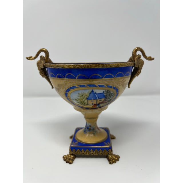 A refined mid-century French Limoges porcelain urn, hand-painted and executed in the neoclassical / Empire revival...