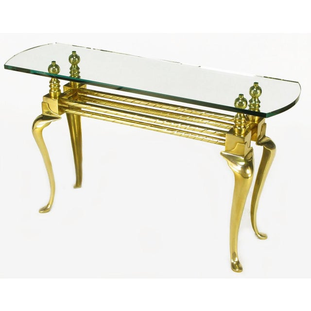 Cast and polished brass cabriole leg glass top console table. Twisted brass tube double stretcher connects brass cubes and...