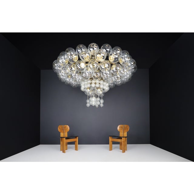 This xxl grande hotel chandelier from the 1960s features a brass fixture and hand-blown glass globes by the renowned...