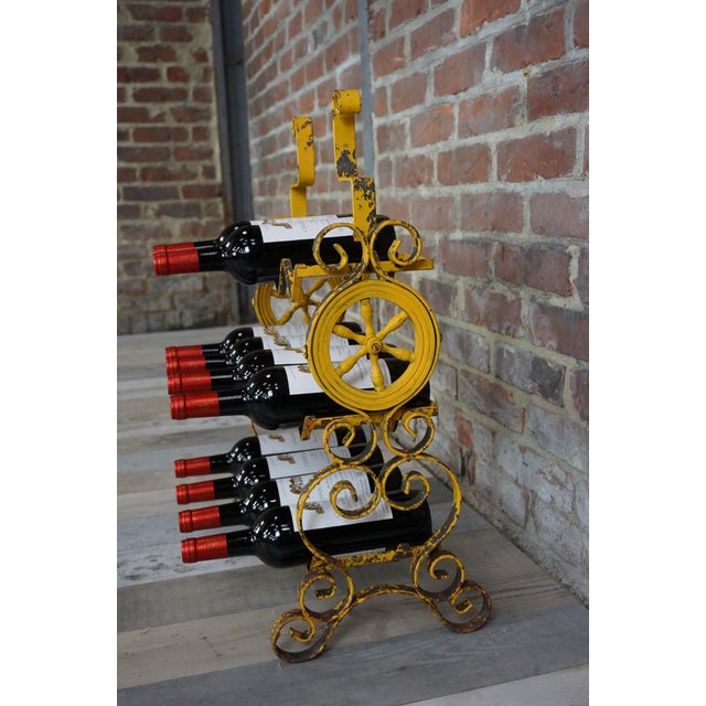 Yellow metal bottle holder with scrollwork and ship's wheel decoration, steeped in time, superb patina. Don't hide your...