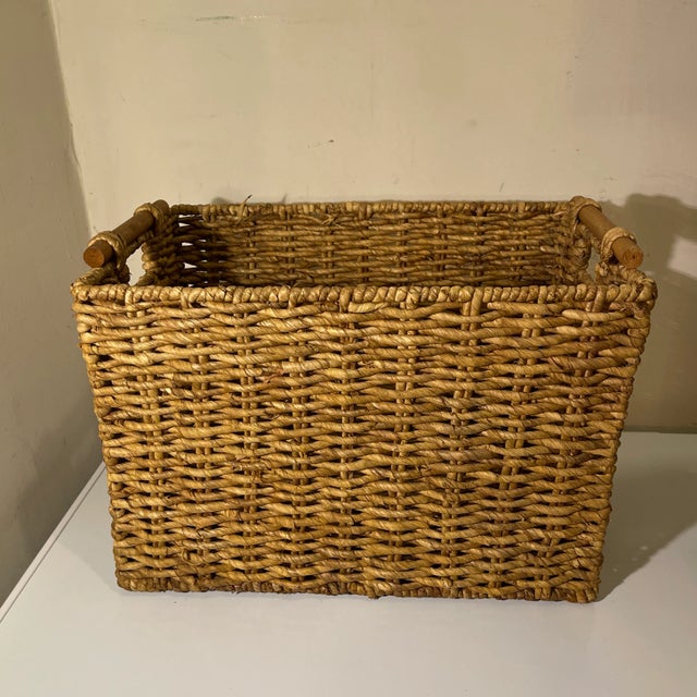 Natural woven raffia rectangle basket with round wooden handles. Great decorative storage, very versatile.