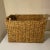 Natural woven raffia rectangle basket with round wooden handles. Great decorative storage, very versatile.