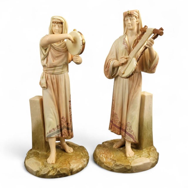 A distinguished pair of large Royal Worcester Egyptian musicians modelled by James Hadley and dated 1893. The tall,...