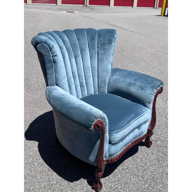 Elegant and substantial, this vintage wingback lounge chair showcases timeless craftsmanship with a beautifully carved...