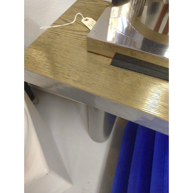 A Bridges over time originals dichotomy console designed by Marco Antonio. It is oak coated in brass on top and steel on...