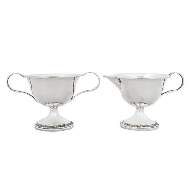 We are thrilled to offer you this sterling silver cream & sugar set in the original box it was presented. Designed by the...