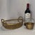 An authentic mid-century set of two hand-woven brass wire tabletop baskets by Castilian Imports, featuring an exceptional...