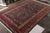 Hand knotted in wool originating circa 1900-1910, this 10x14 antique Persian rug connotes a traditional Bidjar rug design...