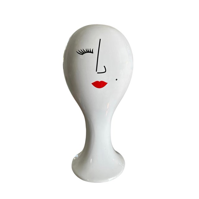 A quirky, vintage ceramic Madame head. Features a balloon style, ceramic bust statue with a winking eye, red lips and a...