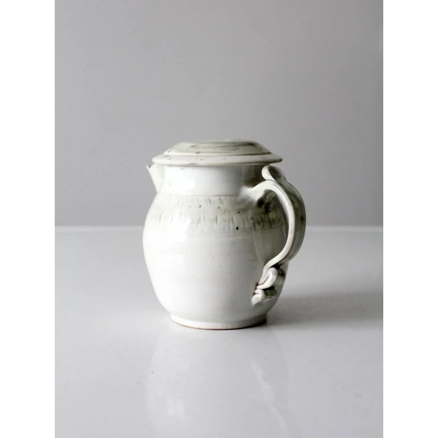 Beautiful vintage handcrafted ceramic teapot, signed by the artist. The softly sculptural form is finished in a luminous...