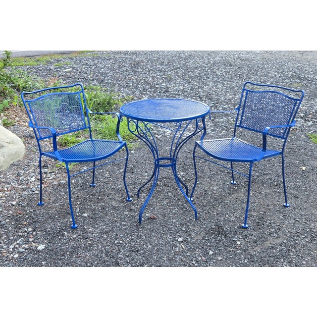 This vintage wrought iron patio set is painted in Ford Blue color. It is a three-piece set consisting of a round table...
