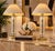 Stunning pair of vintage 1980s table lamps in the style of Gaetano Sciolari, featuring elegant polished brass columns...