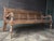 Crafted from durable teak wood, this 20th century bench likely originates from the Dutch Colonial period in Asia. Oswald...