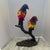Vintage Bronze and Stained Glass Lamps decorated with pair of parrot’s color. Standing on a branch bronze.