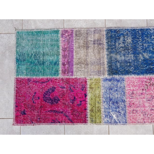 This is a vintage Turkish Oushak rug from the Mid 20th Century. The piece was hand-knotted.