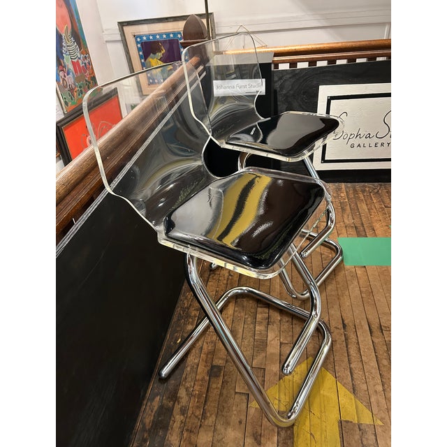 Glamorous midcentury modern pair of designer Luigi Bardini sleek cantilevered tubular chrome frame and transparent acrylic...