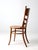 This early 20th-century Continental bentwood ladder-back side chair features clean lines, gently softened curves, and a...