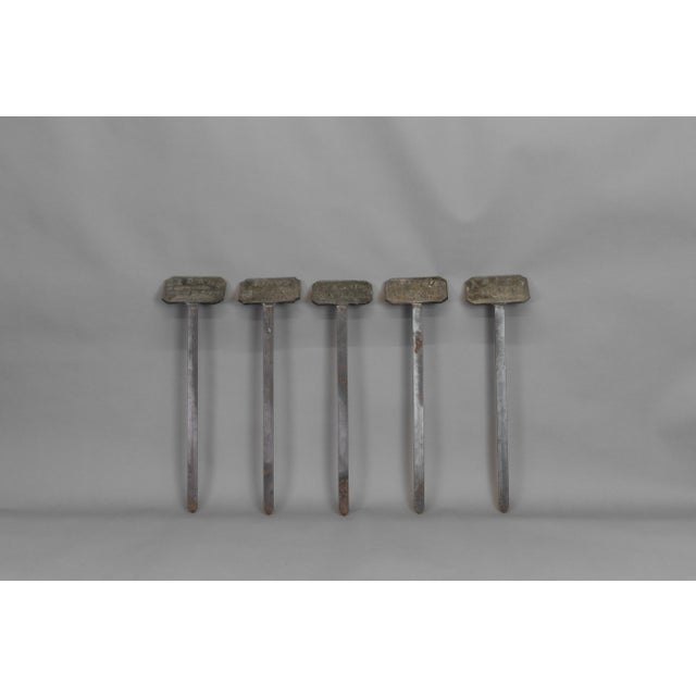 Lead tablet plant labels on spikes. Circa 1900.