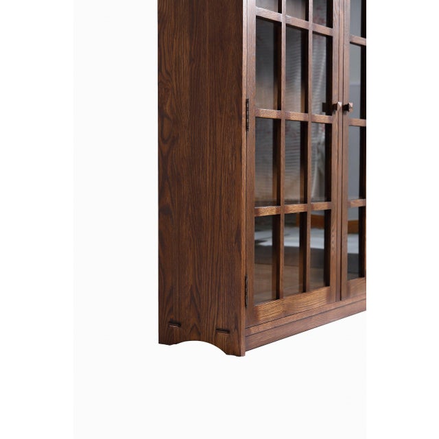 The Mission Oak 2 Door Bookcase with Glass Doors - Walnut is a stunning example of Mission-style craftsmanship. Built from...