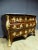 Tomb chest of drawers in marquetry, violet wood, second half of the XVIIIth century. It is curved on all sides and richly...
