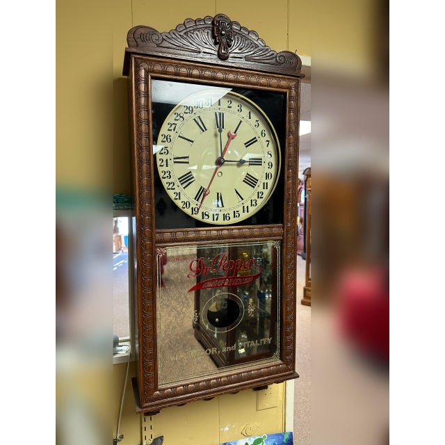 High-quality oak cabinet construction; quartz time-only mechanism with simple calendar and swinging pendulum; circa 1980;...