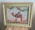 Very decorative embroidered picture with camel and flora. Measures 8” x 10”. Framed under glass in lovely complementary...