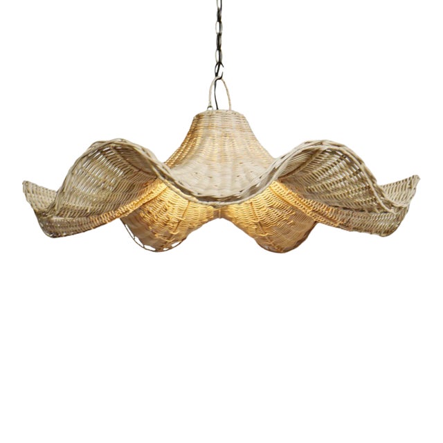 Hand woven raw rattan pendant lantern with stunning wavy skirt design. Each may vary in natural tones, imperfections, and...