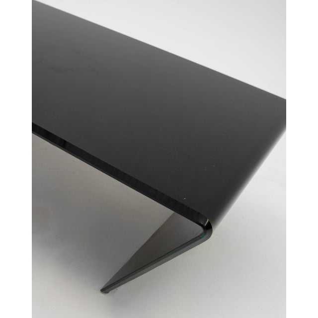 A modern and futuristic coffee table, designed with a space-age and minimalist aesthetic reminiscent of the experimental...