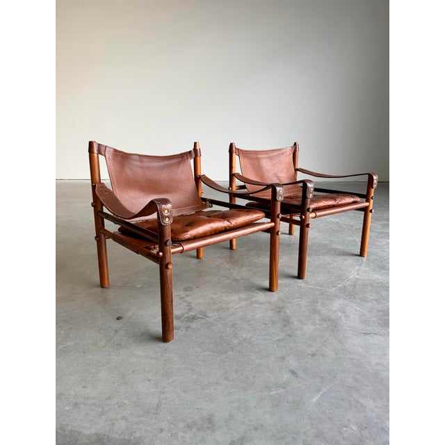 Iconic Mid Century Modern Rosewood and Brown Leather ‘Sirocco’ Safari chair pair designed by Arne Norell, Sweden c.1960’s....