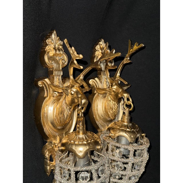 Pair of 20th Century French Louis XVI Gilt Bronze Deer Head Wall Sconces – 2 Pieces Bring regal French refinement into...