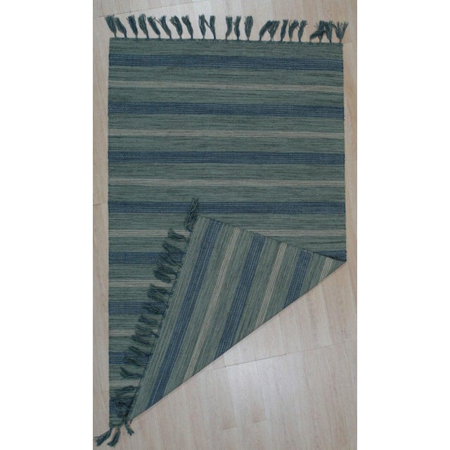 This blue flat weave rug is hand-woven in India using a premium blend of wool and bamboo silk. Designed in the traditional...