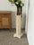 This pedestal columns is painted in a soft cream tone with gilt detailing, produced in the Gustavian style during the 20th...