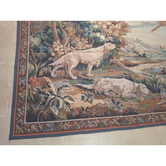Vintage tapestry Aubusson weave handmadefeaturing a classic pastoral hunting scene. The composition depicts two elegant...