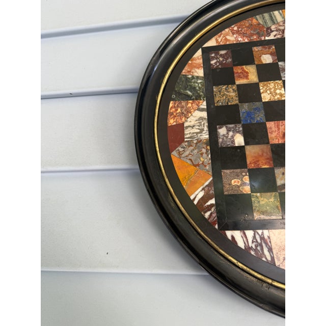 A finely crafted circular pietra dura plaque, likely originating from Italy during the mid-to-late 19th century, this...
