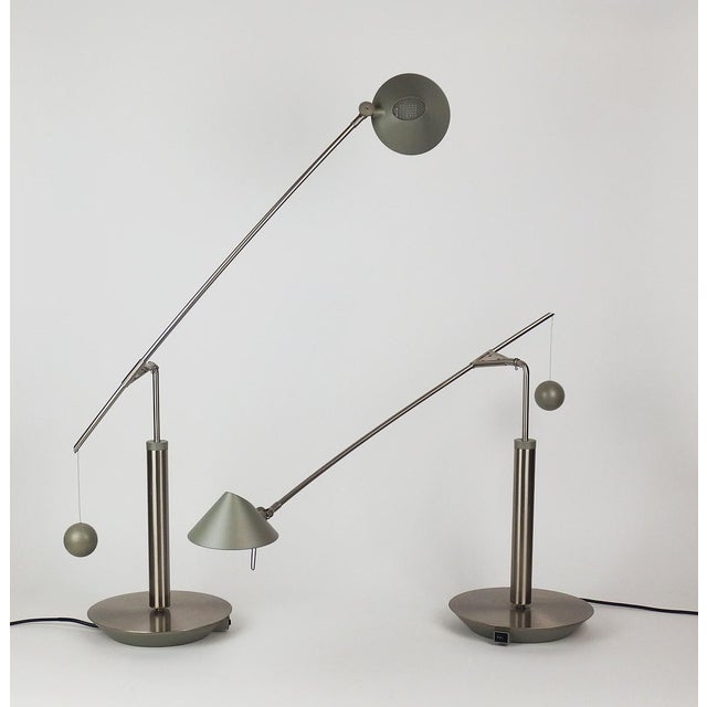 Pair of table or desk lamps with a brushed steel and lacquered metal frame, featuring a counterweight with adjustable...