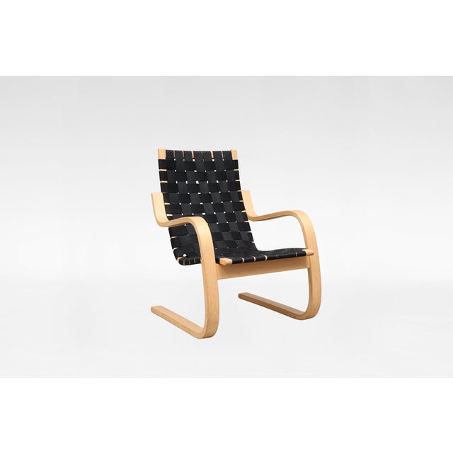 A vintage Alvar Aalto armchair for Artek, designed in Finland during the early Scandinavian modern period. Defined by its...
