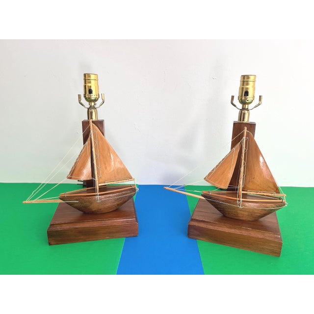 Incredible pair of handmade three-dimensional solid wood sailboat model lamps from the 1960s with dowel masts, booms,...