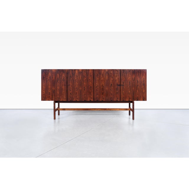 Behold the exquisite Danish modern rosewood sideboard attributed to Ib Kofod Larsen, originating from Denmark in the...