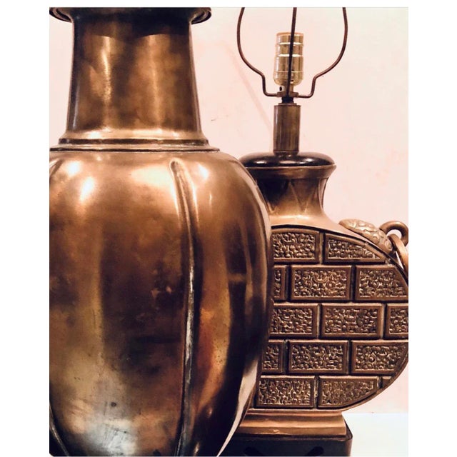 A large brass mid century bulbous lamp in textured design. There are coordinating handles on the sides, an original round...