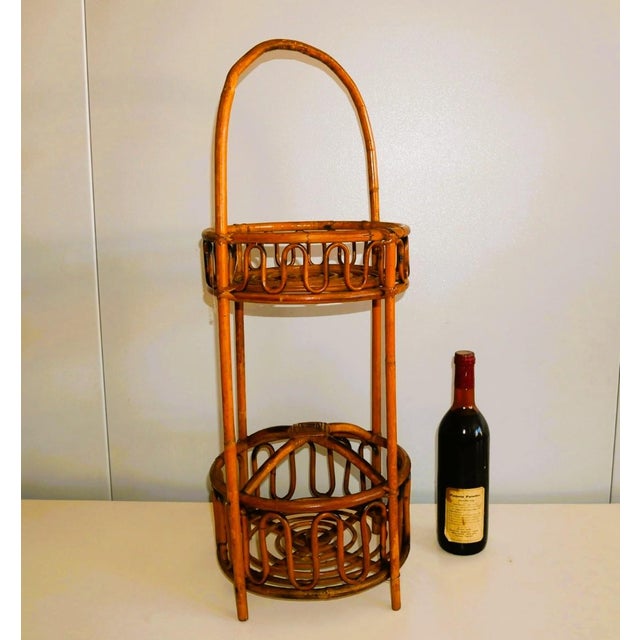 Small bottle holder/bamboo/wicker objects, 1960s/70s Round model with arched handle. Two shelves, the bottom one divided...