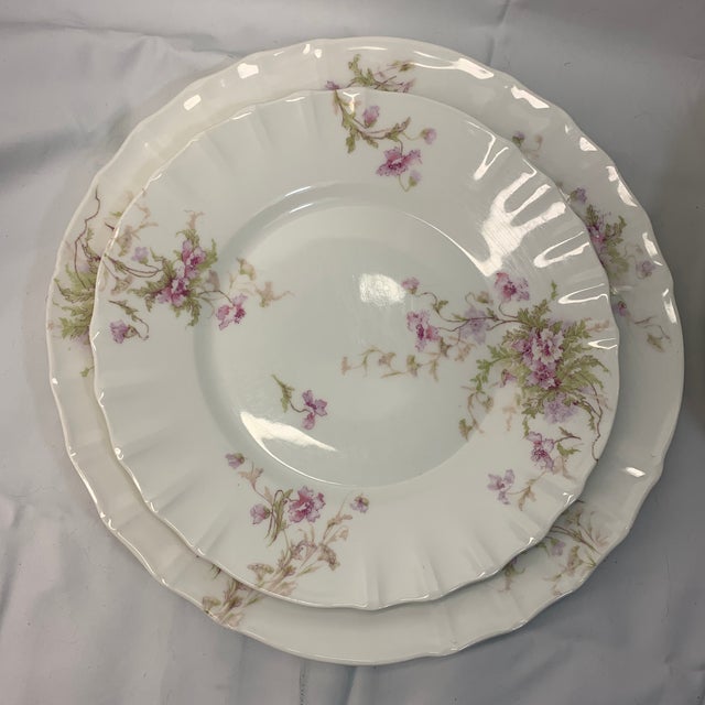 Offered here are vintage Theodore Haviland Limoges porcelain plates decorated with delicate pink and purple floral sprays...