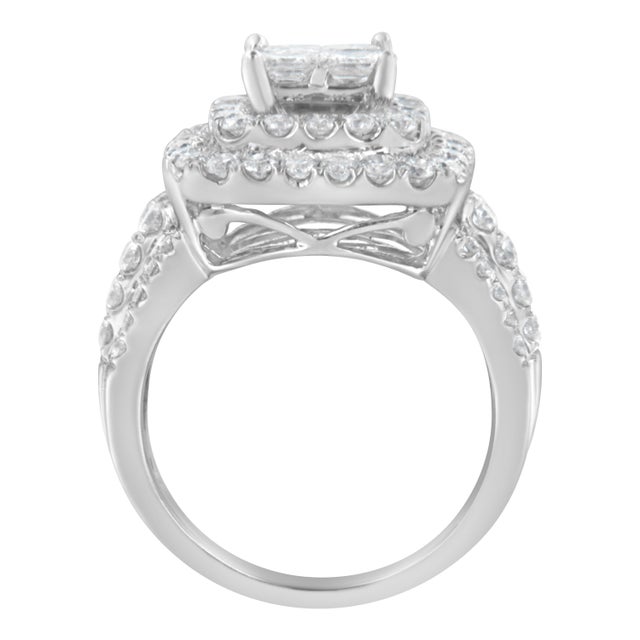 A diamond cocktail ring that sparkles with a central square cluster of princess cut diamonds surrounded by a double halo...