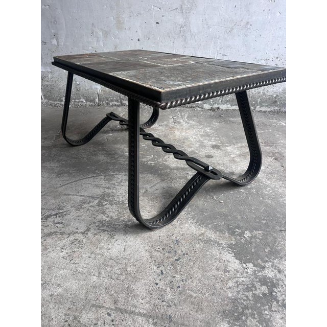 Elegant French Art Deco coffee table dating from circa 1930. The rectangular tabletop is composed of natural slate tiles...